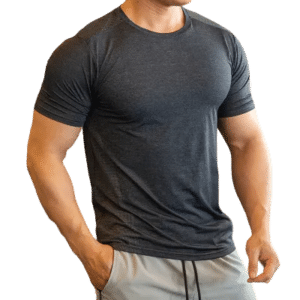 Muscular man in gray t-shirt and shorts showcasing fitness and style.